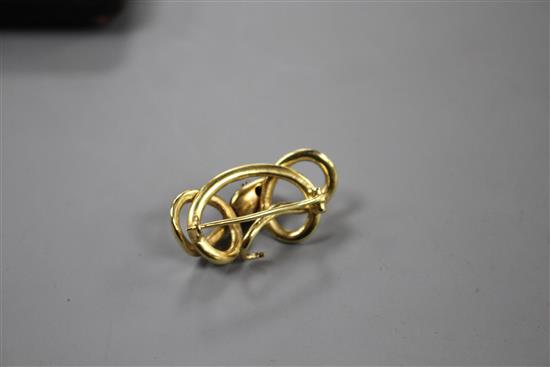 A late Victorian yellow and white metal, sapphire and diamond set scrolling serpent brooch, 32mm, gross 4.5 grams.